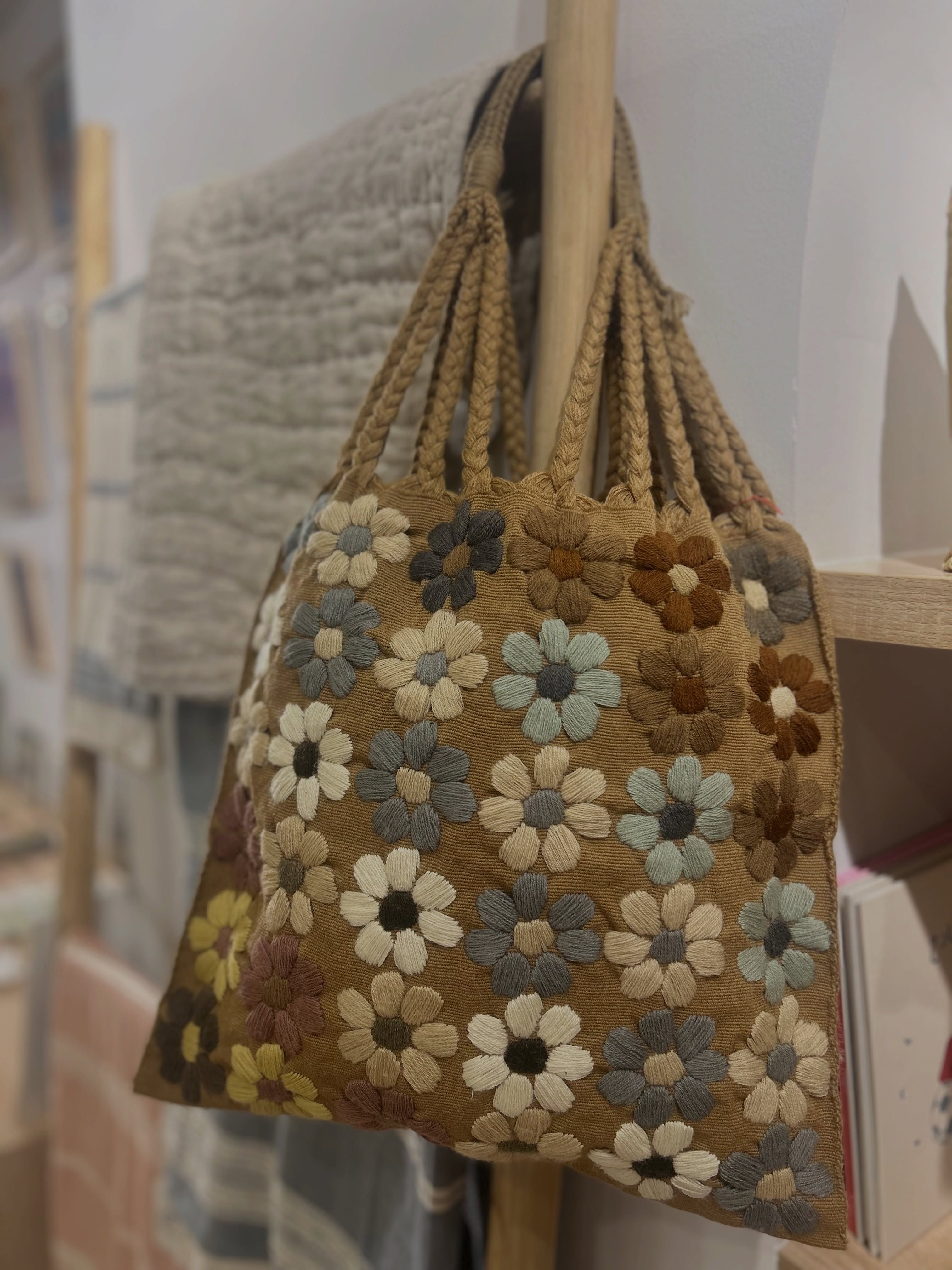 A richly embroidered floral bag displayed in the Min’na boutique