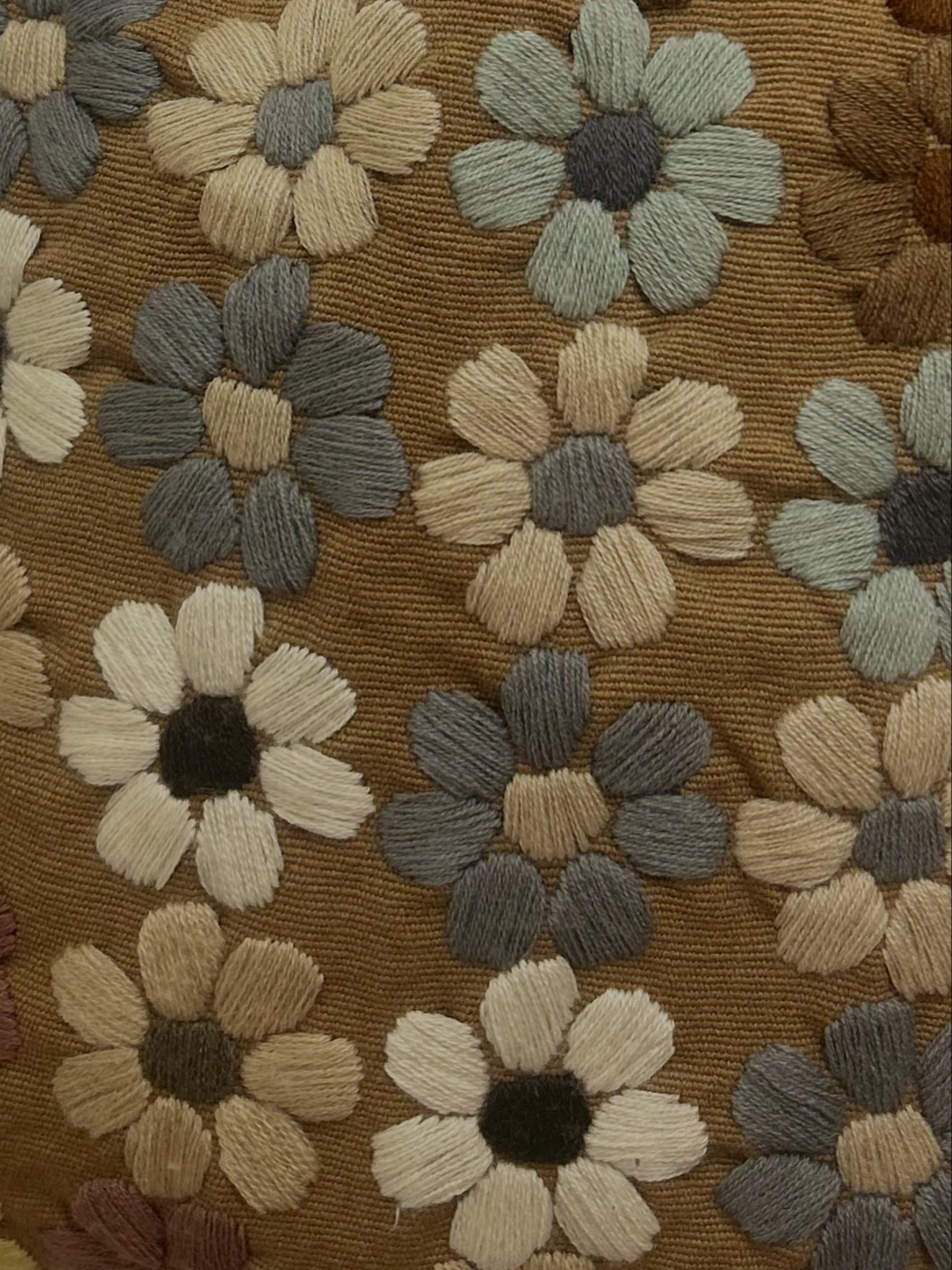 A close view of richly textured floral hand embroidery